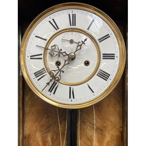 50 - A Victorian walnut and ebonised cased Vienna wall clock with pendulum, weights and winder - approx. ... 