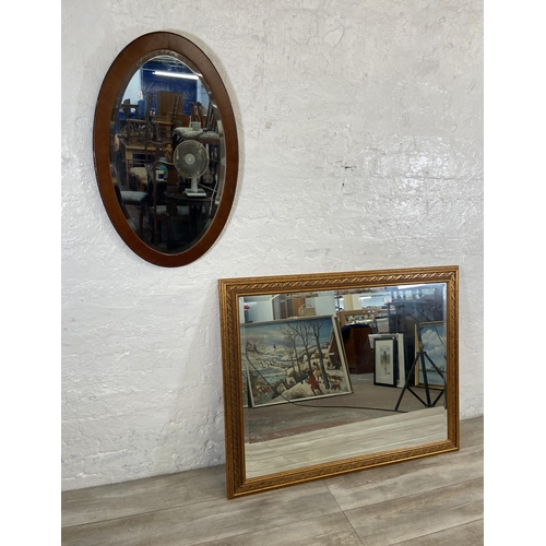 54 - Two bevelled edge wall mirrors, one gilt framed rectangular - approx. 90cm high x 115cm wide and one... 