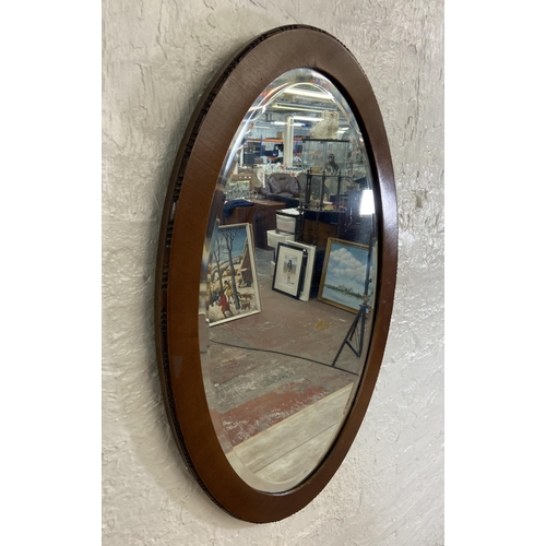 54 - Two bevelled edge wall mirrors, one gilt framed rectangular - approx. 90cm high x 115cm wide and one... 