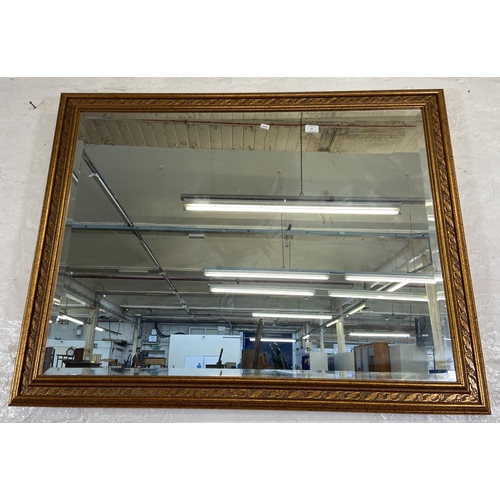 54 - Two bevelled edge wall mirrors, one gilt framed rectangular - approx. 90cm high x 115cm wide and one... 