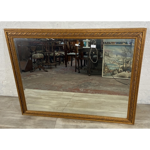 54 - Two bevelled edge wall mirrors, one gilt framed rectangular - approx. 90cm high x 115cm wide and one... 