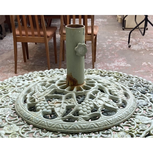 55 - A Victorian style green painted cast metal five piece patio set comprising circular table, three arm... 