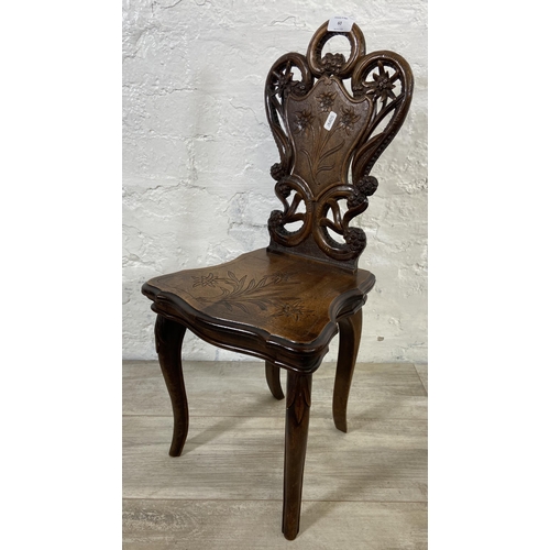 60 - A late 19th century Black Forest carved walnut musical hall chair - approx. 68cm high x 32cm wide x ... 