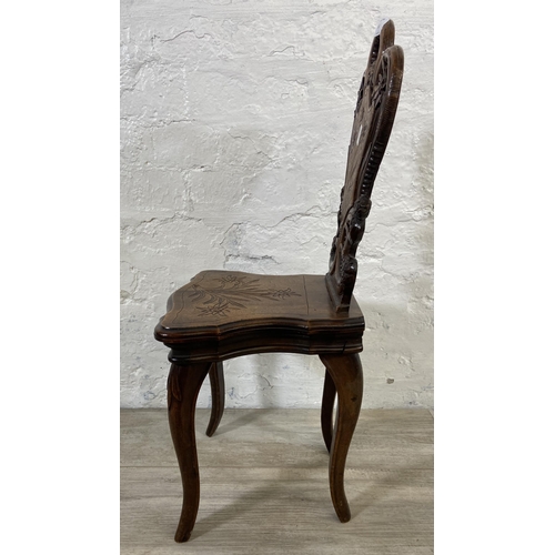 60 - A late 19th century Black Forest carved walnut musical hall chair - approx. 68cm high x 32cm wide x ... 