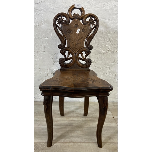 60 - A late 19th century Black Forest carved walnut musical hall chair - approx. 68cm high x 32cm wide x ... 