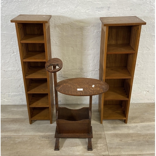 61 - Three pieces of oak furniture, one 1930s magazine rack side table with ashtray holder and two CD rac... 