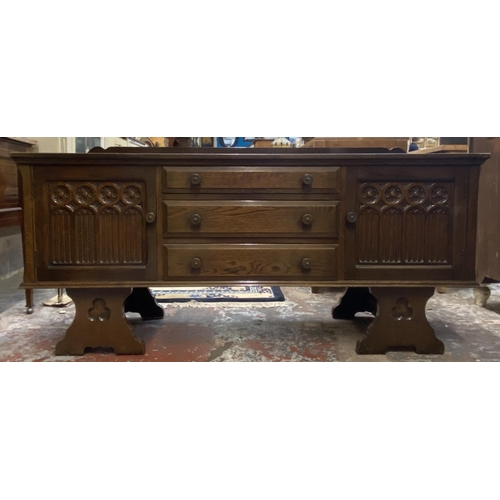 62 - A Gothic style carved oak dressing table - approx. 74cm high x 152cm wide x 45cm deep