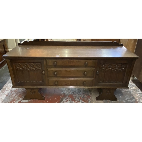 62 - A Gothic style carved oak dressing table - approx. 74cm high x 152cm wide x 45cm deep