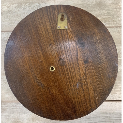 7 - Two early 20th century oak items, one British made circular wall hanging barometer - approx. 26cm di... 