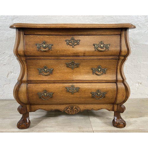 70 - An 18th century style Dutch oak bombe chest of drawers on ball and claw supports - approx. 61cm high... 