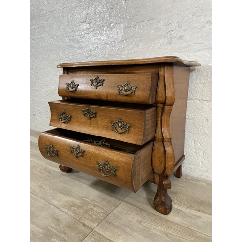 70 - An 18th century style Dutch oak bombe chest of drawers on ball and claw supports - approx. 61cm high... 