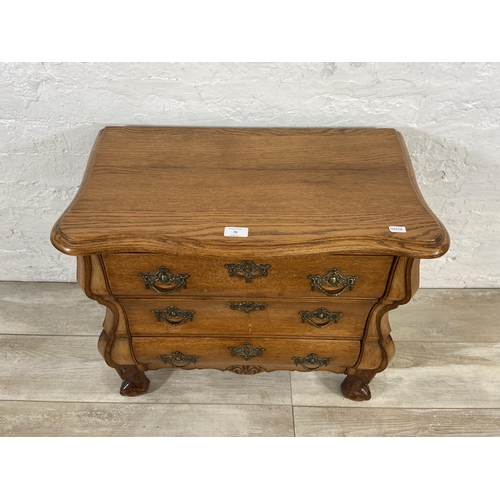 70 - An 18th century style Dutch oak bombe chest of drawers on ball and claw supports - approx. 61cm high... 