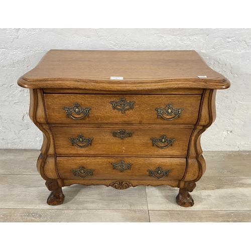 70 - An 18th century style Dutch oak bombe chest of drawers on ball and claw supports - approx. 61cm high... 