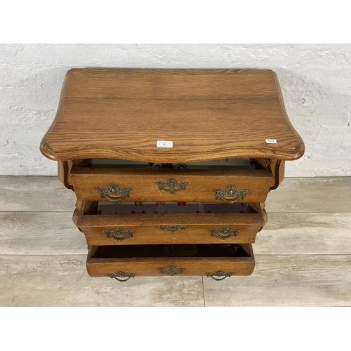 70 - An 18th century style Dutch oak bombe chest of drawers on ball and claw supports - approx. 61cm high... 