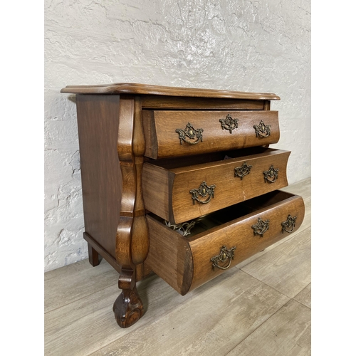 70 - An 18th century style Dutch oak bombe chest of drawers on ball and claw supports - approx. 61cm high... 