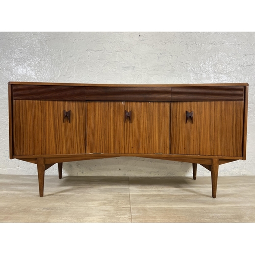 71 - A mid 20th century Elliotts of Newbury zebrano and teak concaved sideboard - approx. 76cm high x 150... 