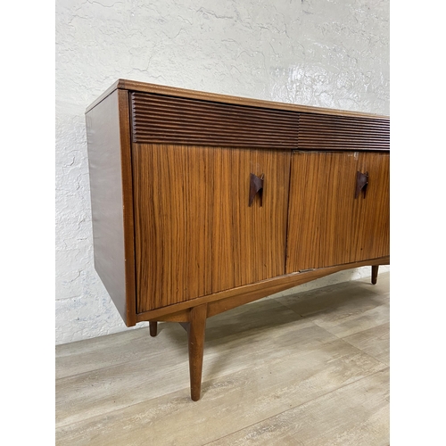 71 - A mid 20th century Elliotts of Newbury zebrano and teak concaved sideboard - approx. 76cm high x 150... 