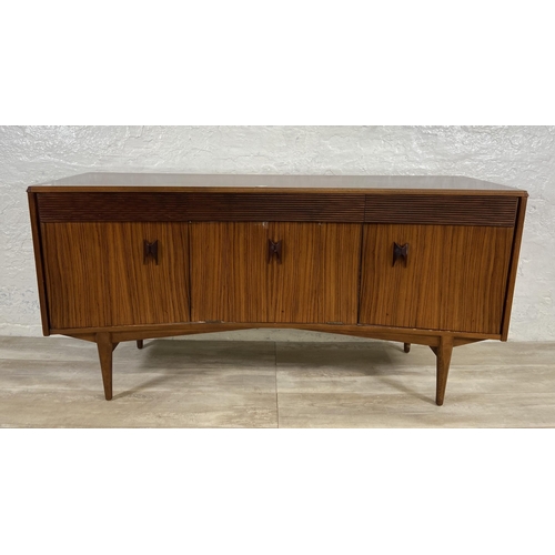 71 - A mid 20th century Elliotts of Newbury zebrano and teak concaved sideboard - approx. 76cm high x 150... 