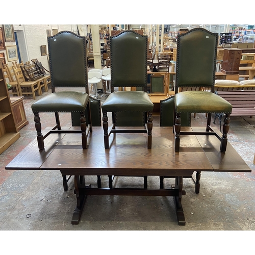 75 - A 17th century style oak rectangular refectory dining table and six green vinyl upholstered dining c... 