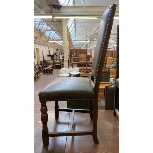 75 - A 17th century style oak rectangular refectory dining table and six green vinyl upholstered dining c... 