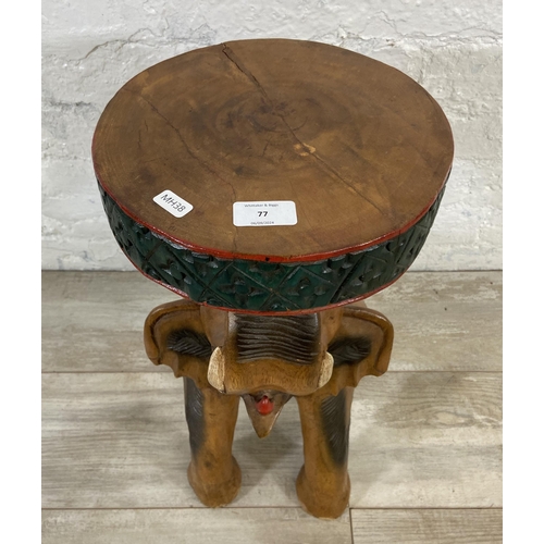 77 - A carved hardwood elephant side table - approx. 52cm high x 25cm diameter