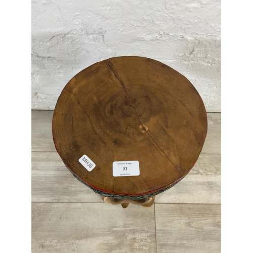 77 - A carved hardwood elephant side table - approx. 52cm high x 25cm diameter