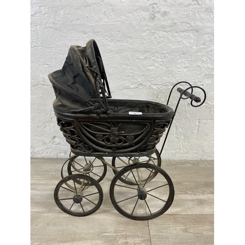 80 - A Victorian style wicker and metal doll's pram - approx. 60cm high