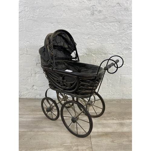 80 - A Victorian style wicker and metal doll's pram - approx. 60cm high