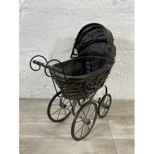 80 - A Victorian style wicker and metal doll's pram - approx. 60cm high