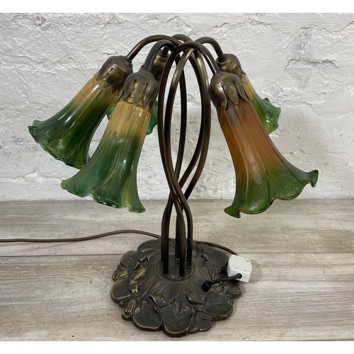 81 - An Art Nouveau style bronzed lily pad table lamp with five green and yellow mottled glass shades - a... 