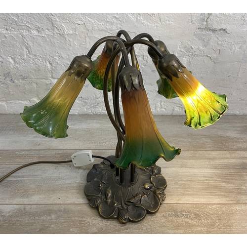 81 - An Art Nouveau style bronzed lily pad table lamp with five green and yellow mottled glass shades - a... 