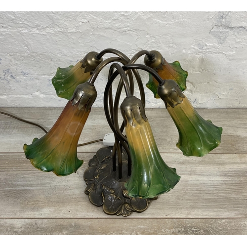 81 - An Art Nouveau style bronzed lily pad table lamp with five green and yellow mottled glass shades - a... 