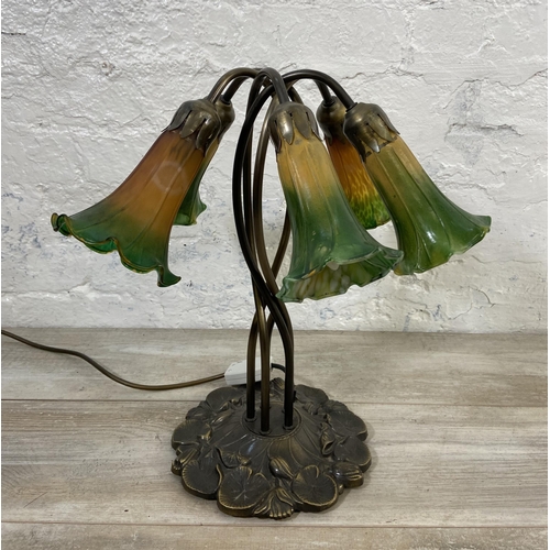 81 - An Art Nouveau style bronzed lily pad table lamp with five green and yellow mottled glass shades - a... 