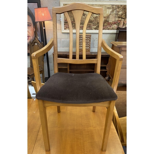 83 - A mid 20th century teak drop leaf gate leg dining table and two Morris of Glasgow elm and brown fabr... 