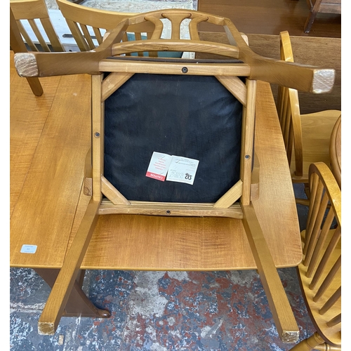 83 - A mid 20th century teak drop leaf gate leg dining table and two Morris of Glasgow elm and brown fabr... 