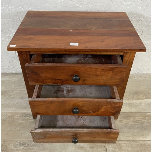 84 - An Indian sheesham wood bedside chest of drawers - approx. 60cm high x 60cm wide x 40cm deep