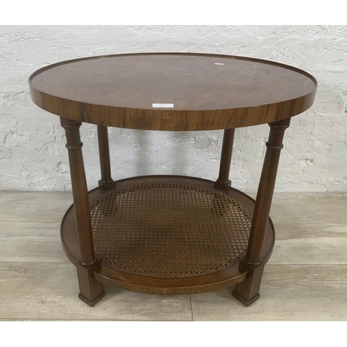 9 - An Art Deco style burr walnut and rattan oval two tier side table - approx. 56cm high x 56cm wide x ... 