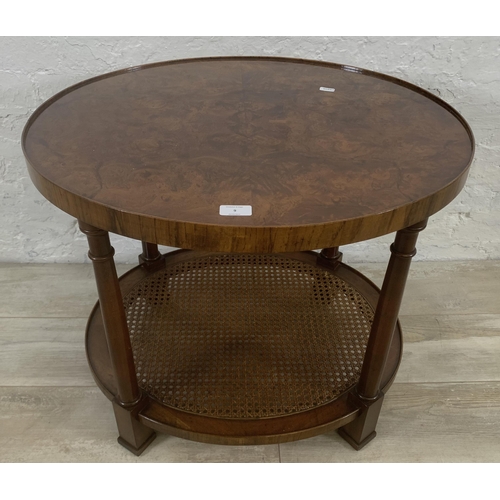 9 - An Art Deco style burr walnut and rattan oval two tier side table - approx. 56cm high x 56cm wide x ... 