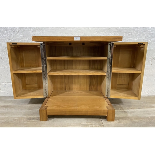 91 - A modern oak two door storage/media cabinet - approx. 59cm high x 56cm wide x 40cm deep