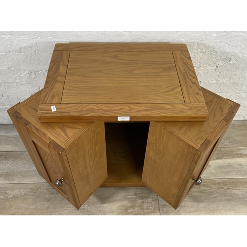 91 - A modern oak two door storage/media cabinet - approx. 59cm high x 56cm wide x 40cm deep