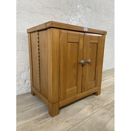 91 - A modern oak two door storage/media cabinet - approx. 59cm high x 56cm wide x 40cm deep