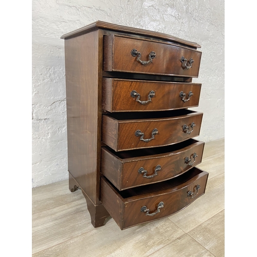 94 - A mahogany serpentine miniature chest of drawers on bracket supports - approx. 70cm high x 45cm wide... 