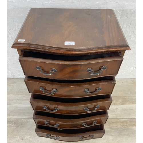 94 - A mahogany serpentine miniature chest of drawers on bracket supports - approx. 70cm high x 45cm wide... 