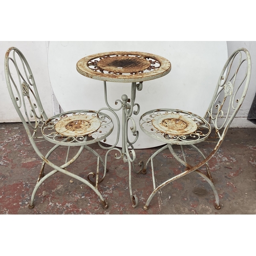 99 - A Victorian style grey painted wrought metal three piece patio set - table approx. 79cm high x 50cm ... 