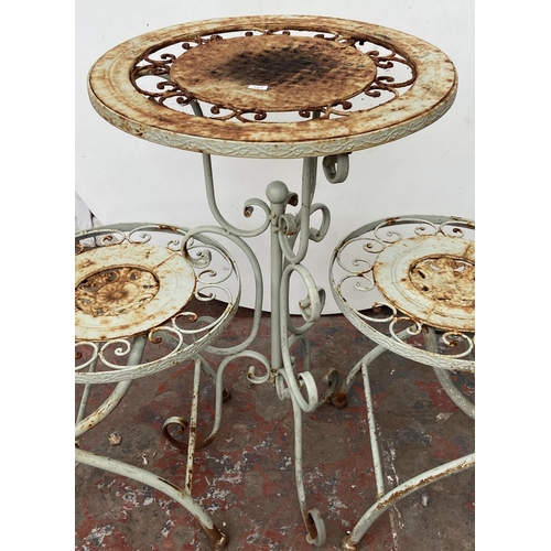 99 - A Victorian style grey painted wrought metal three piece patio set - table approx. 79cm high x 50cm ... 