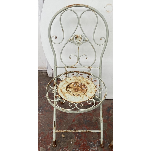 99 - A Victorian style grey painted wrought metal three piece patio set - table approx. 79cm high x 50cm ... 