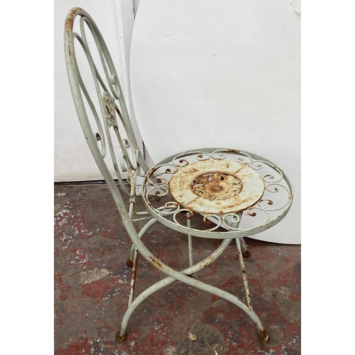 99 - A Victorian style grey painted wrought metal three piece patio set - table approx. 79cm high x 50cm ... 