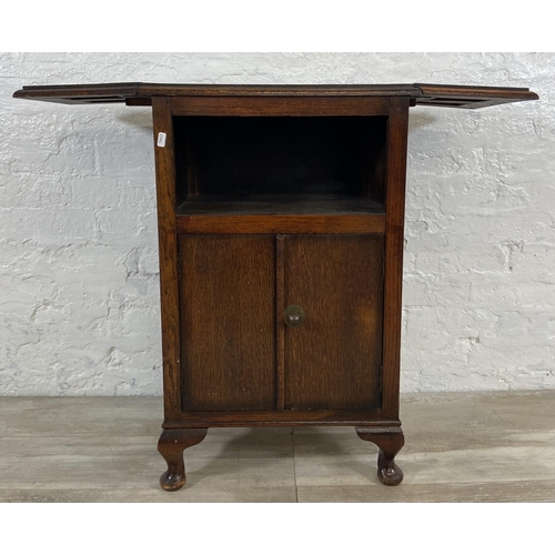 165 - A 1930s oak drop leaf two door cabinet on cabriole supports - approx. 79cm high x 92cm wide x 31cm d... 