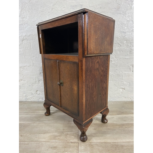 165 - A 1930s oak drop leaf two door cabinet on cabriole supports - approx. 79cm high x 92cm wide x 31cm d... 