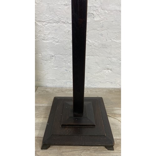 38A - Two mid 20th century ebonised floor standing lamps, each approx. 157cm high